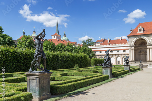 Statues along an alley and Sala Terrena (Garden Pavilion) at the Wallenstein (Waldstein) Garden. It's a public Baroque garden at the Lesser Town (Mala Strana) in Prague, Czech Republic. photo