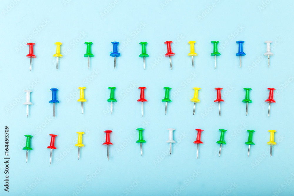 back to school concept. pin on blue background. flat lay back to school concept. pin on blue background. flat lay