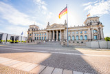 View on the famous Reichtag parliament building with flag during the morning light in Berlin city