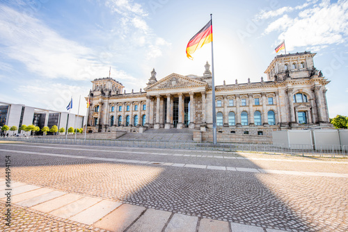 View on the famous Reichtag parliament building with flag during the morning light in Berlin city photo