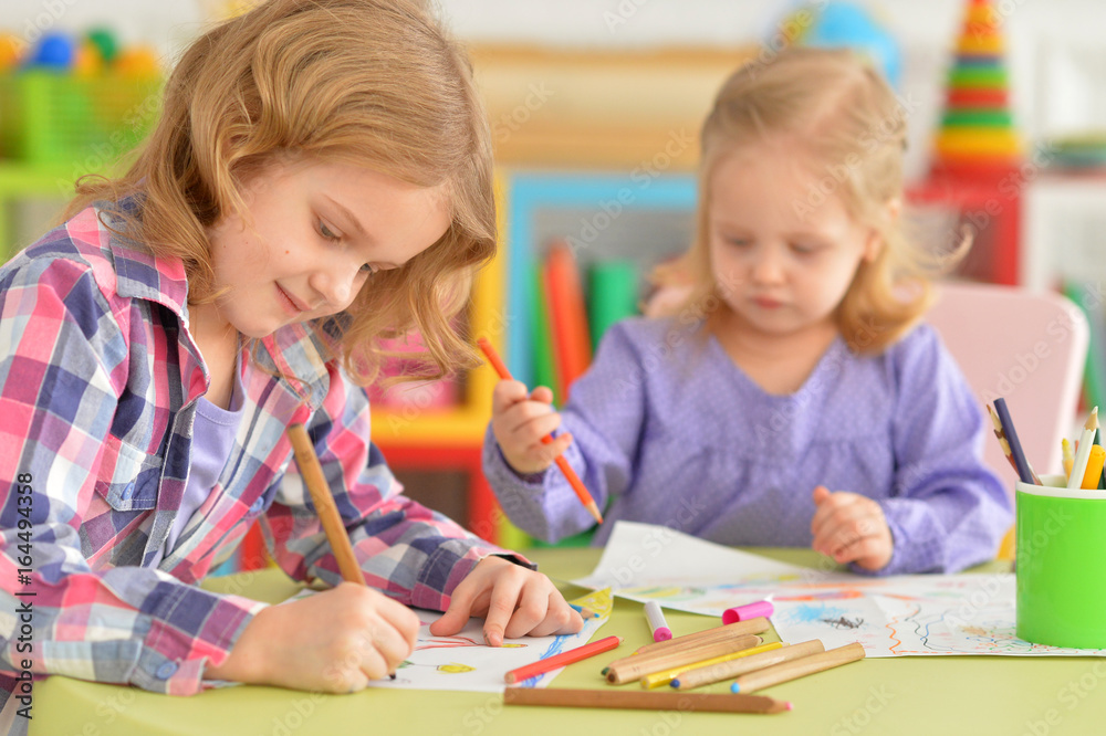 Cute little girls drawing with pencils Cute little girls drawing with pencils