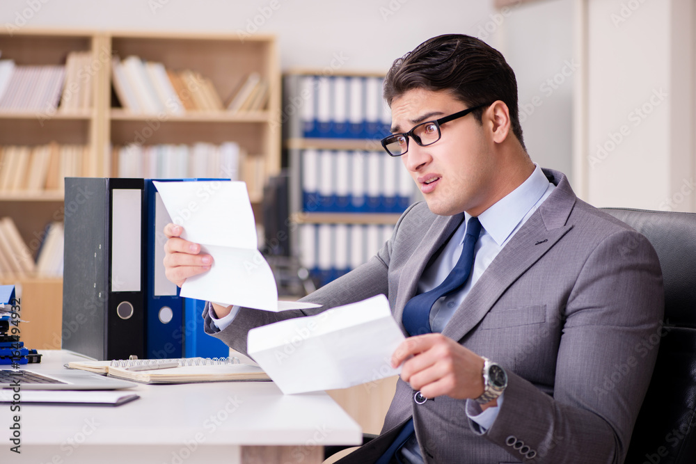 Businessman receiving letter in the office Businessman receiving letter in the office