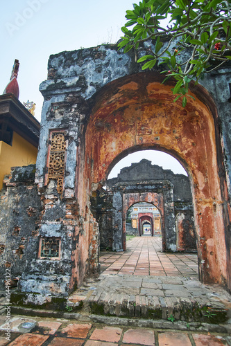 Traditional vietnamese entrance door in the imperial city  Hue  Vietnam  on a foggy day.