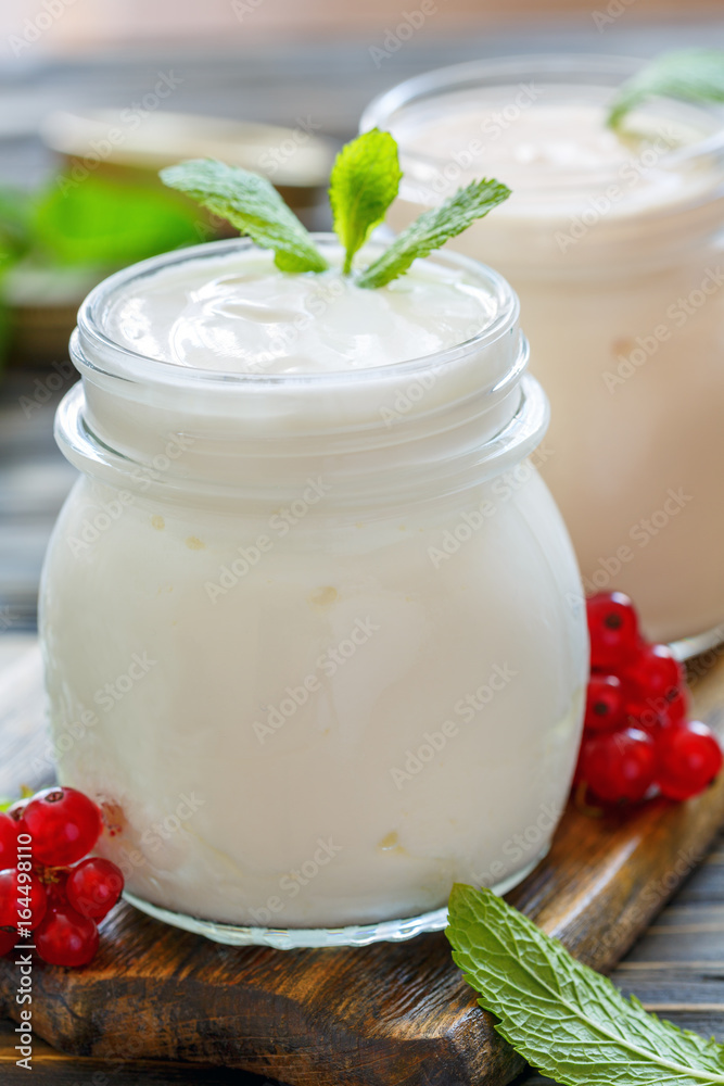 Homemade yoghurt in a glass jar closeup. Homemade yoghurt in a glass jar closeup.