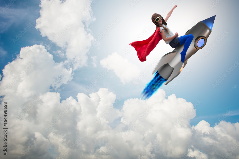 Little girl flying rocket in superhero concept Little girl flying rocket in superhero concept