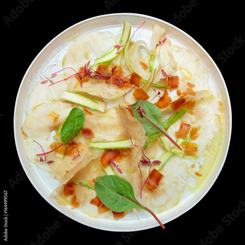 Carpaccio from artichoke and bottarga isolated on black photo