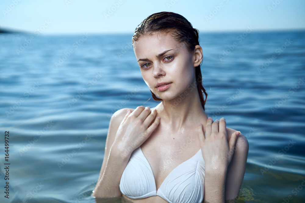 Fototapeta premium Beautiful young woman resting on the sea, beach, summer, vacation