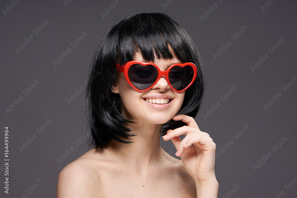 Beautiful young woman on a black background in sunglasses-hearts Beautiful young woman on a black background in sunglasses-hearts