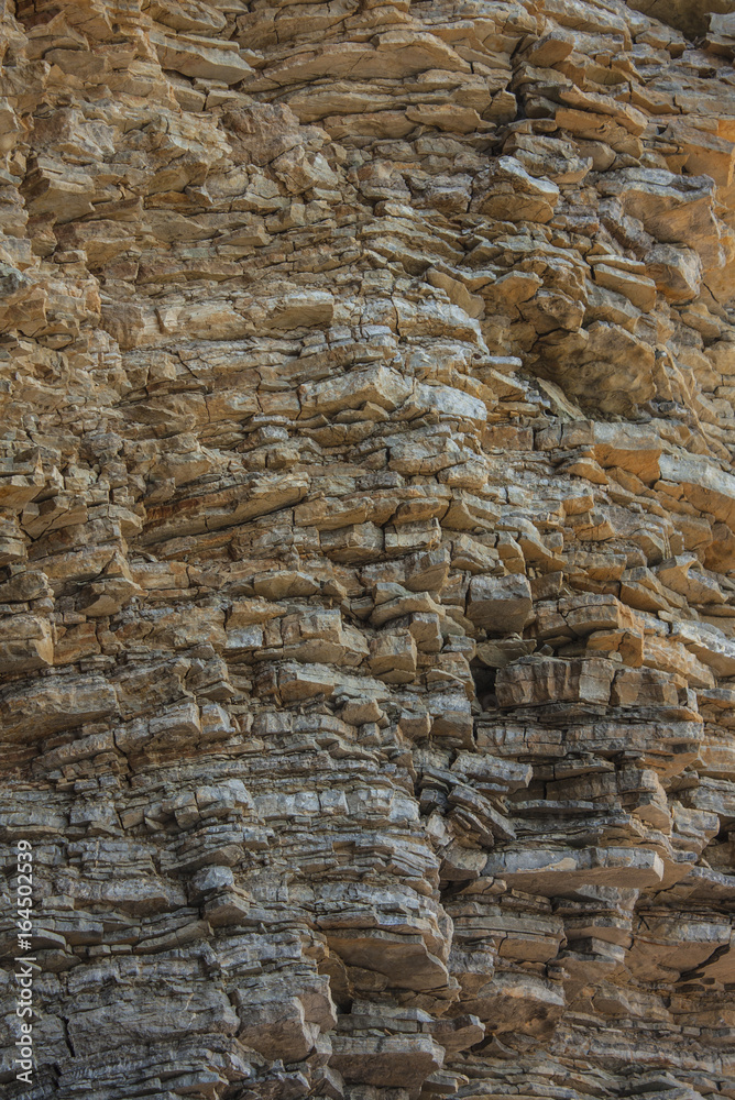 Cliff of rock mountain. Texture of the rock. Close-up.  Surface of the rock, stone background and texture.