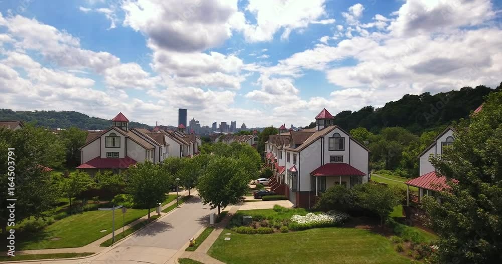 A rising aerial establishing shot of the upscale residential homes on Washington's Landing Island with the Pittsburgh skyline in the distance. A rising aerial establishing shot of the upscale residential homes on Washington's Landing Island with the Pittsburgh skyline in the distance.