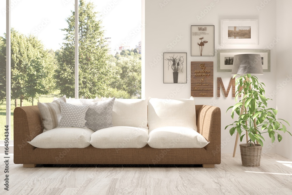 Fototapeta premium Idea of white room with sofa and summer landscape in window. Scandinavian interior design. 3D illustration