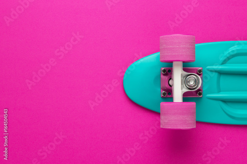 plastic mini cruiser board on deep pink with background with copy space