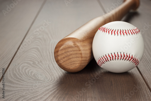 Photography closeup of baseball bat and ball on wooden table with copy space