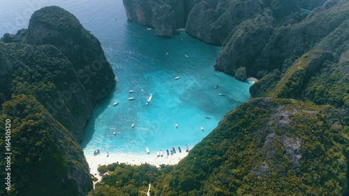 Aerial drone view of iconic tropical turquoise water Maya Bay surrounded by limestone cliffs, Phi Phi islands, Thailand