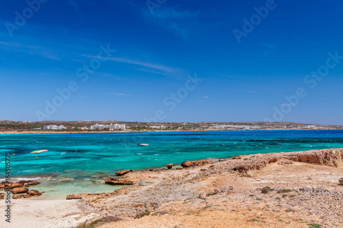 Beautiful landscape sand beach near of Nissi beach and Cavo Greco in Ayia Napa, Cyprus island, Mediterranean Sea. Amazing blue green sea and sunny day. © oleg_p_100