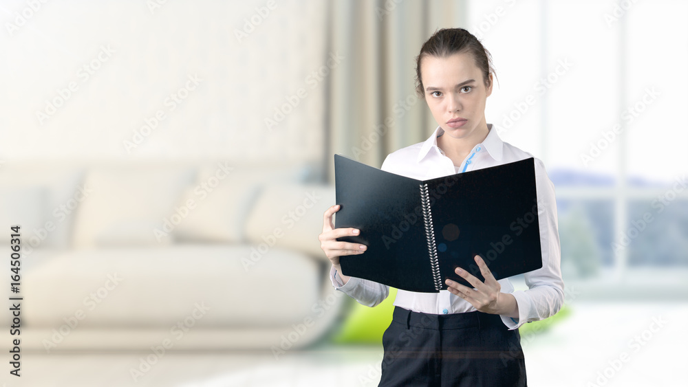 Young beautiful business woman and creative designer standing over blured interior background Young beautiful business woman and creative designer standing over blured interior background