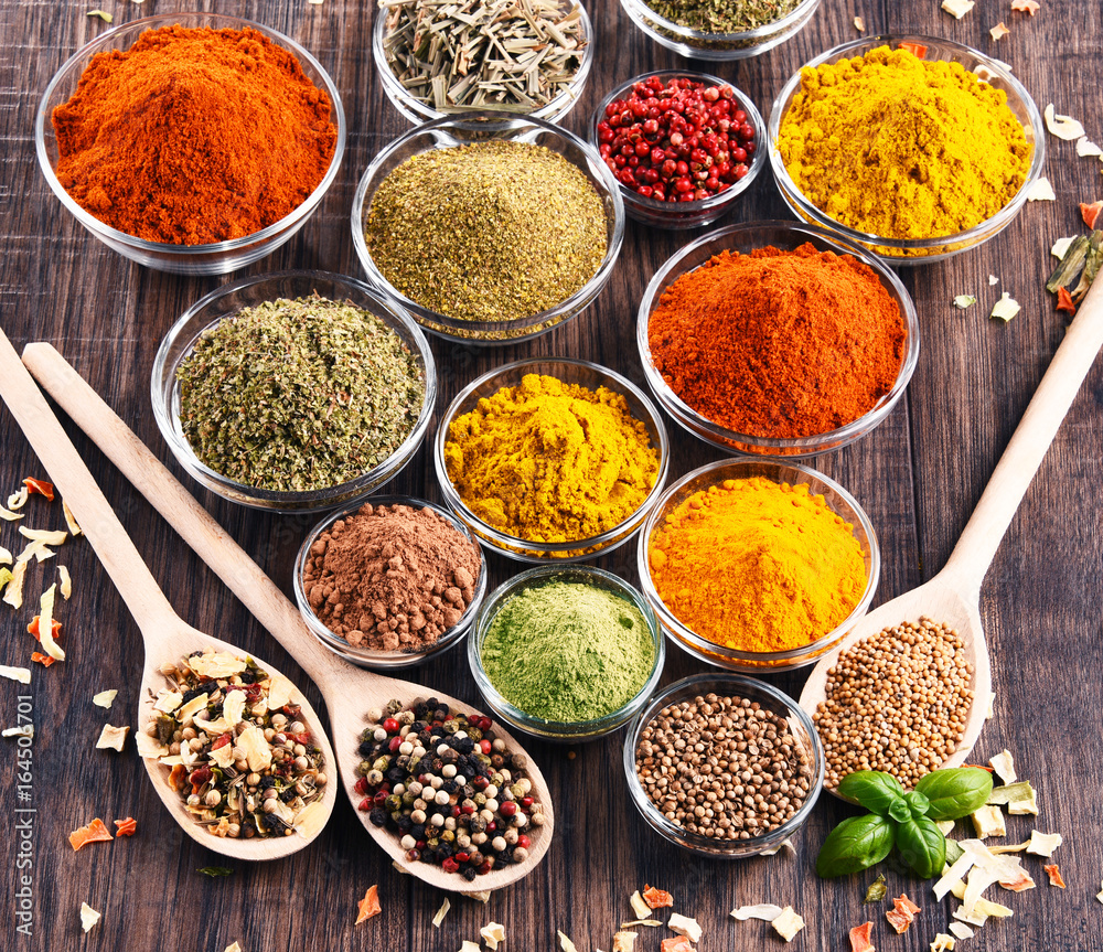 Variety of spices and herbs on kitchen table Variety of spices and herbs on kitchen table