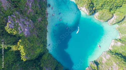 Aerial drone view of tropical turquoise water Loh Samah Bay surrounded by limestone cliffs, Phi Phi islands, Thailand
