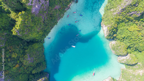 Aerial drone view of tropical turquoise water Loh Samah Bay surrounded by limestone cliffs, Phi Phi islands, Thailand
