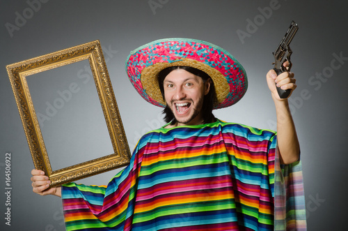 Man in a vivid mexican poncho gray background isolated
