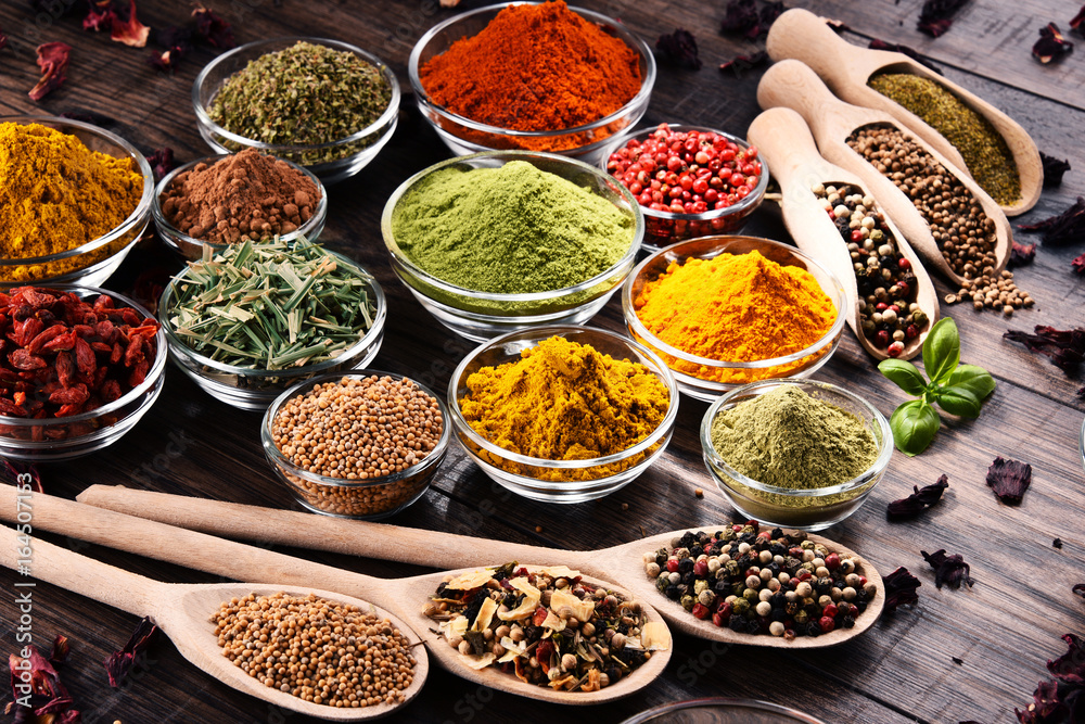 Variety of spices and herbs on kitchen table Variety of spices and herbs on kitchen table