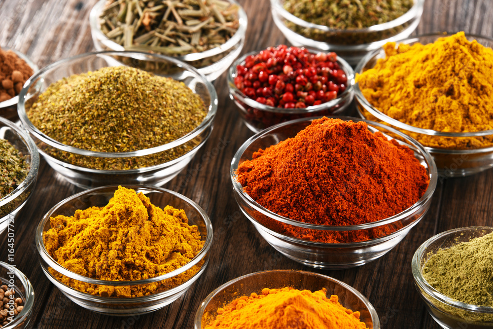 Variety of spices and herbs on kitchen table Variety of spices and herbs on kitchen table