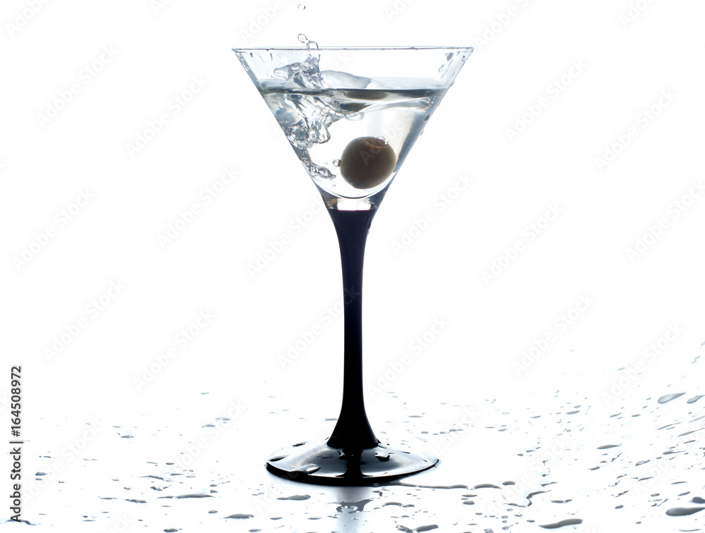 Cocktail martini with olive, a splash of vermouth in a glass