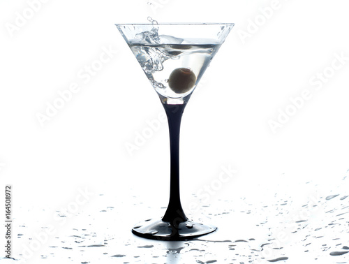 Cocktail martini with olive  a splash of vermouth in a glass