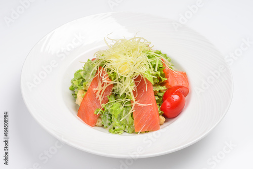 Caesar salad with smoked salmon. White background, menu concept.