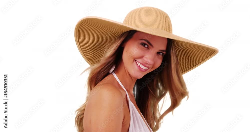 Close up of young Caucasian woman in bikini posing with floppy hat on white background. Closeup of attractive female modeling trendy sunhat in studio. 4k Close up of young Caucasian woman in bikini posing with floppy hat on white background. Closeup of attractive female modeling trendy sunhat in studio. 4k