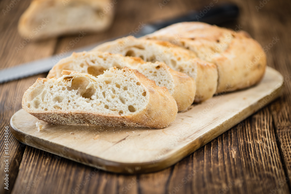 Fresh made Baguette on a rustic background Fresh made Baguette on a rustic background