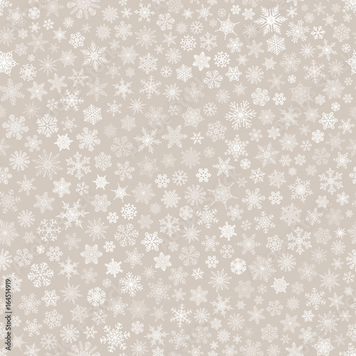 Seamless pattern of snowflakes, white on beige