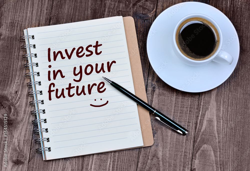 The words Invest in your future on notebook The words Invest in your future on notebook