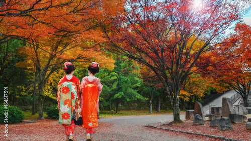Geisha Girls in a Japanese Garden in Colorful Autumn