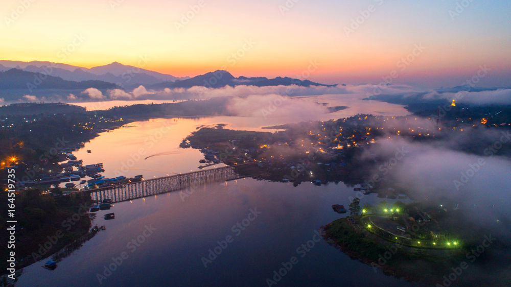 Aerial view and morning mist top view at Sangkhlaburi. It is a popular place for tourists. Images may be blurry due to fog.