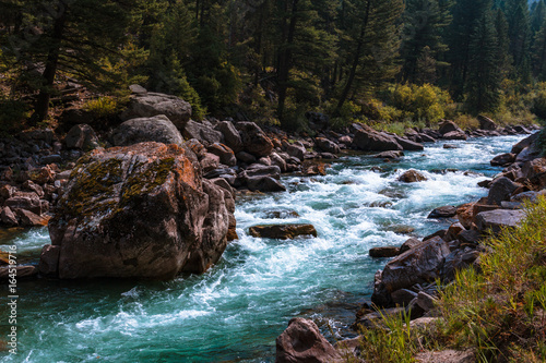 Rugged Mountain Stream. Giant Boulder in Fresh Water. Gallatin, Montana. Impressive Copy Space. © boundlessimages
