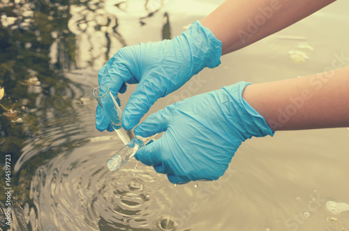 Taking a water test for analysis from a reservoir.