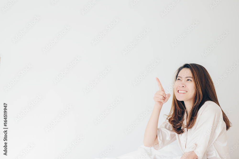 Portrait of asian women pointing at white background. Portrait of asian women pointing at white background.