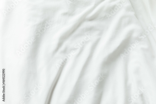 Top view of white bedding sheets after wake up in the morning