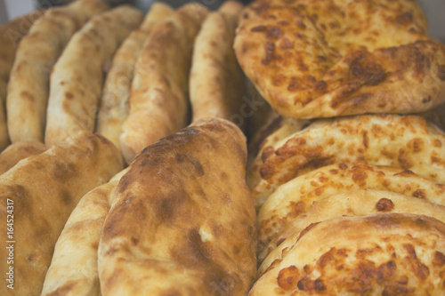 Khachapuri closeup with the egg, the Georgian cuisine. Street food. © Igorzvencom