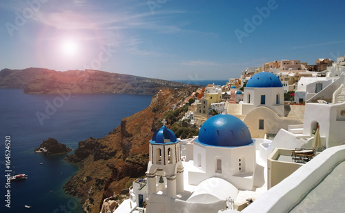 Photo of the famous bright blue domes in the centre of Oia on Santorini island (romantic treatment)