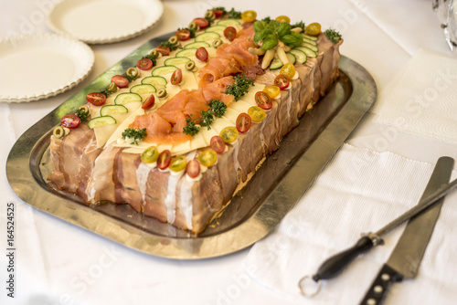 special traditional Sandwich cake layers with ham, vegetables cheese and sauces