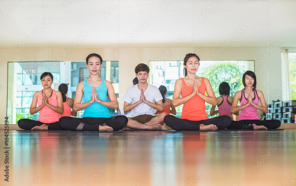 Yoga class in studio room,Group of people doing namaste pose with clam relax emotion,Meditation pose,Wellness and Healthy Lifestyle Yoga class in studio room,Group of people doing namaste pose with clam relax emotion,Meditation pose,Wellness and Healthy Lifestyle