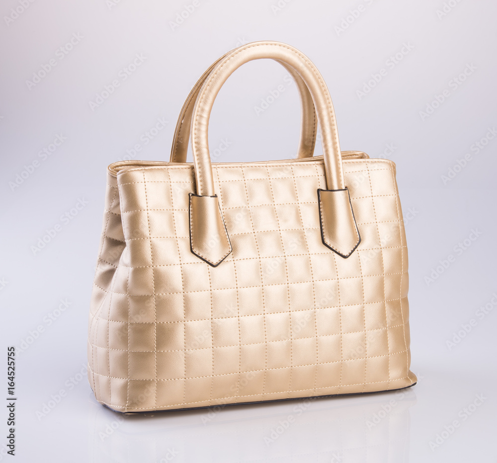 bag or gold colour handbag on background. bag or gold colour handbag on background.