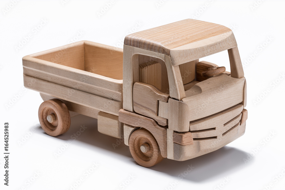 The truck is a toy made of natural wood.
