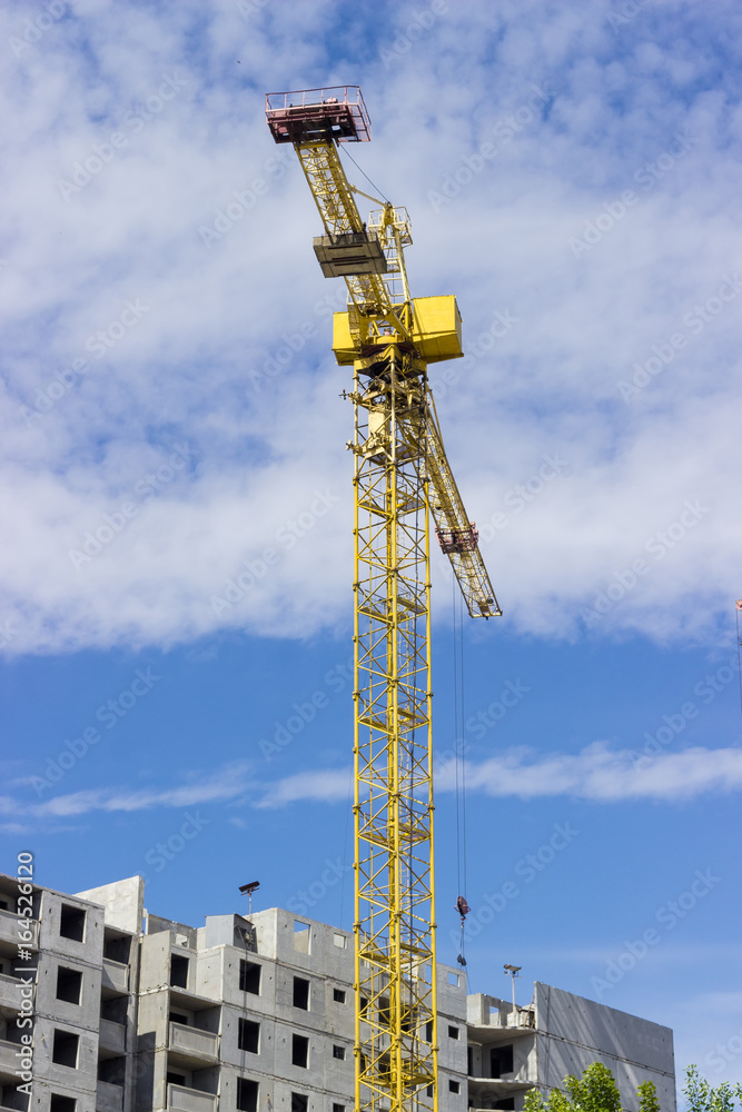 Tower crane against of multi-story residential building Tower crane against of multi-story residential building
