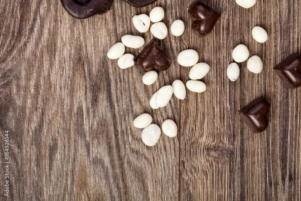 Heart shape chocolate on wooden background in studio photo Heart shape chocolate on wooden background in studio photo