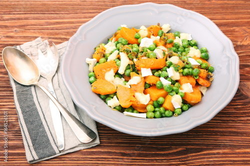 Warm salad with roasted pumpkin, peas and cheese brie