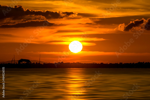 Beautiful sunset at the lake. © noppharat