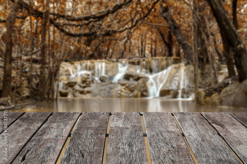 Blur image of Brown forest and Small waterfall background